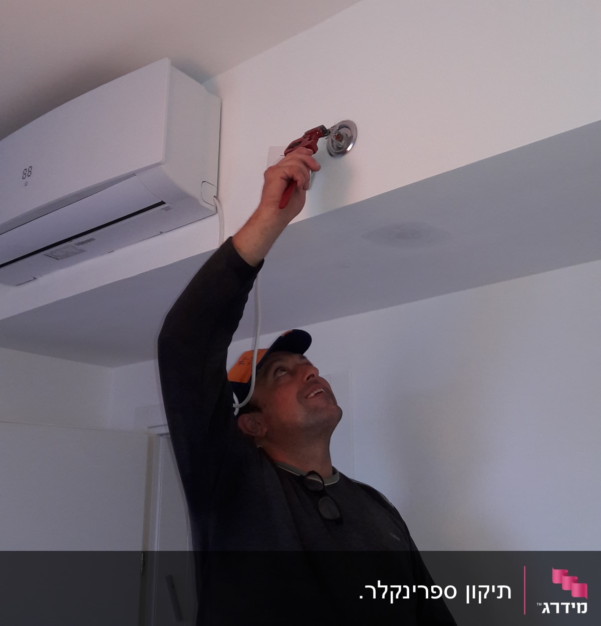 אדם משתמש במפתח צינורות לתיקון צינור